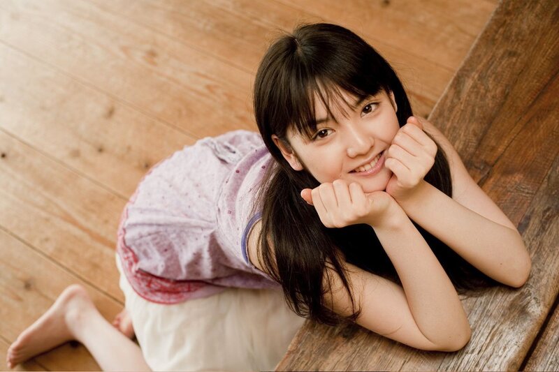 girl smiling on wooden floor