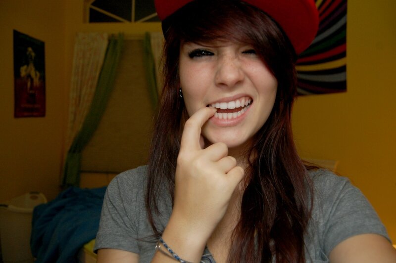 girl smiling with finger in mouth