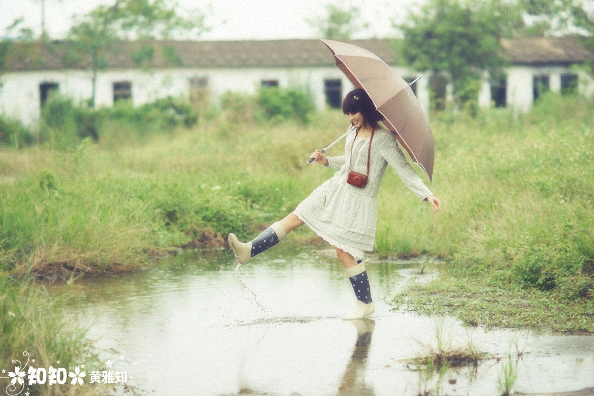 Girl splashing in a puddle