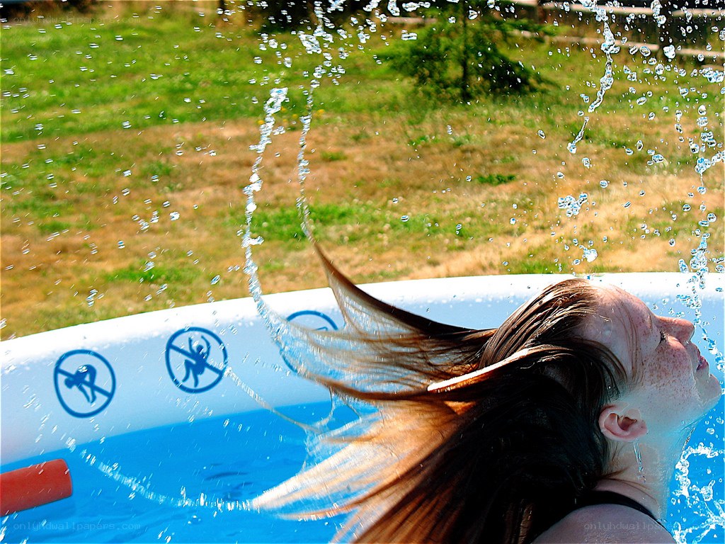 girl splashing in pool