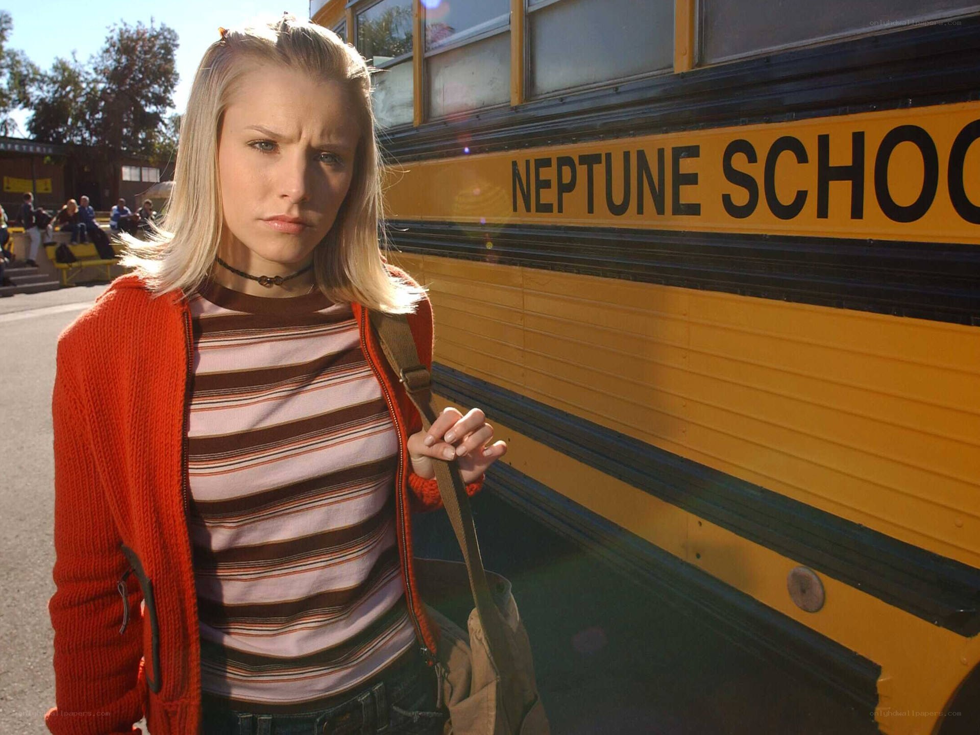 girl standing by school bus