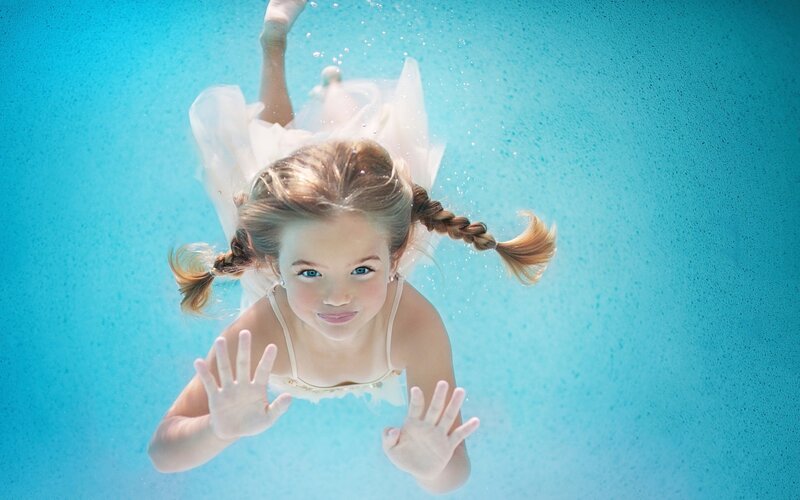 Girl Swimming Underwater — Blue, Serene, Photograph