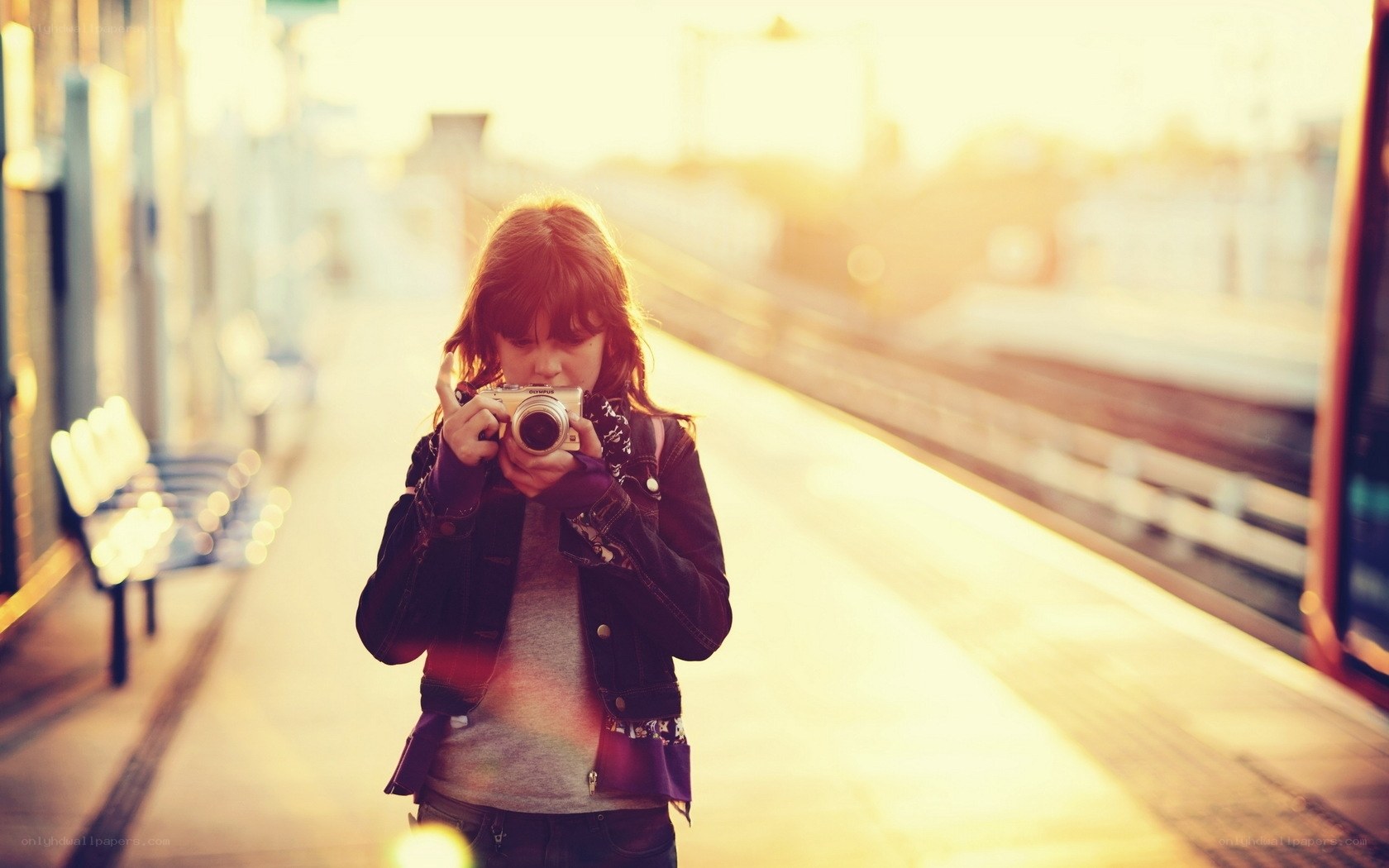 Girl taking a photo at sunset
