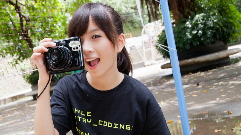 girl taking a photo outdoors