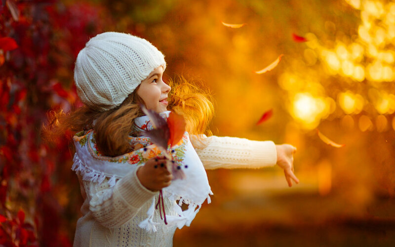 Girl Throwing Leaves — Orange