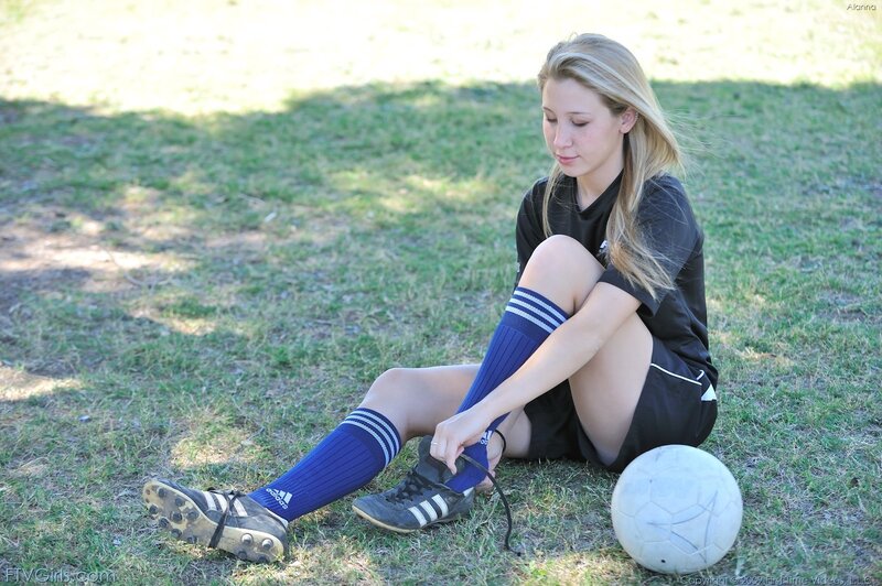 girl tying soccer shoes