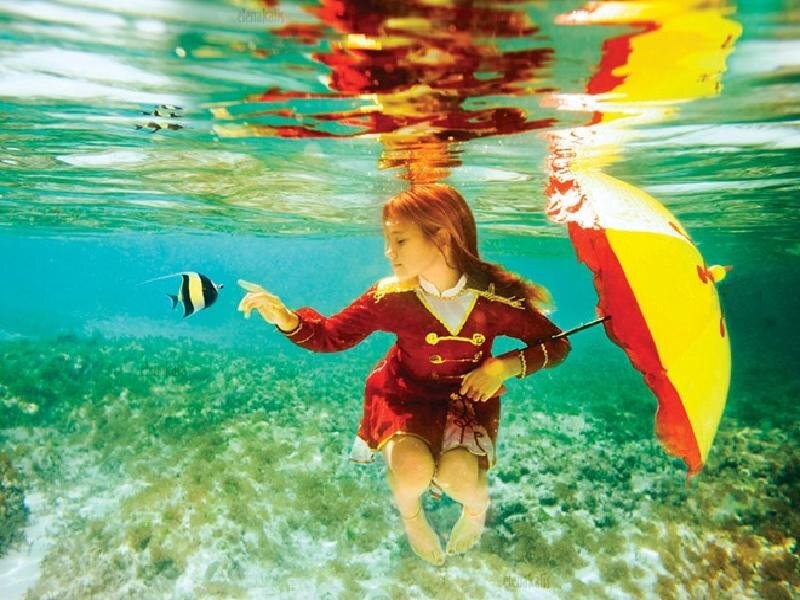 girl underwater with umbrella