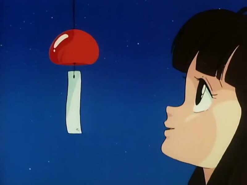 girl watching a wind chime