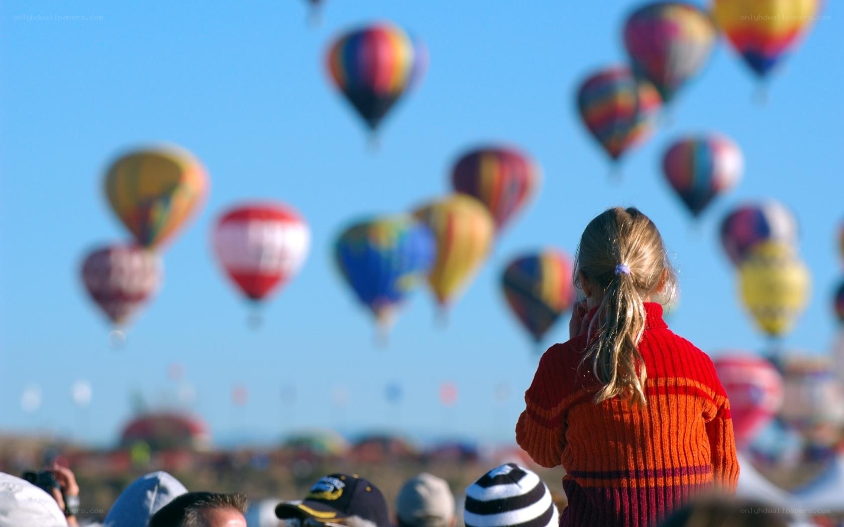 Girl watching hot air balloons