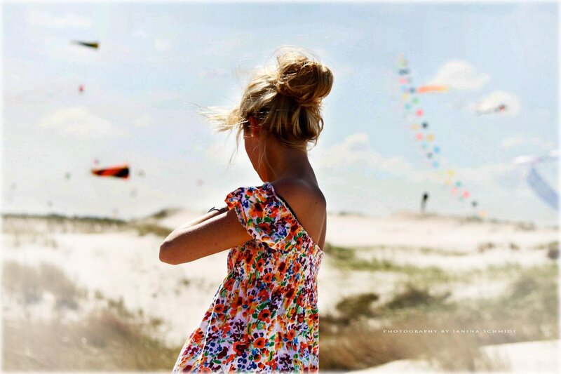 Girl watching kites at the beach