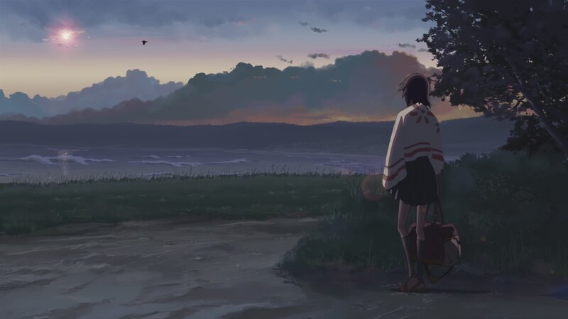 Girl watching sunset by the sea