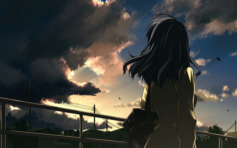 girl watching sunset from bridge