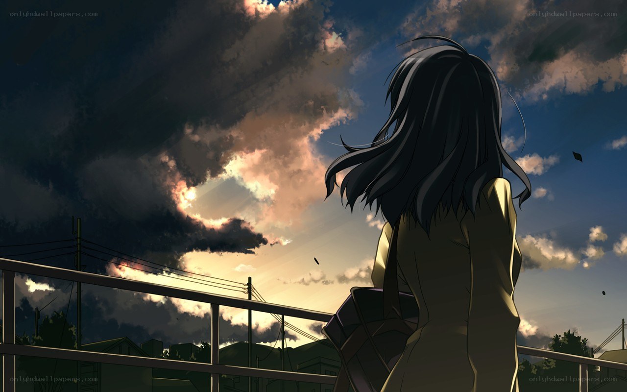 girl watching sunset from bridge