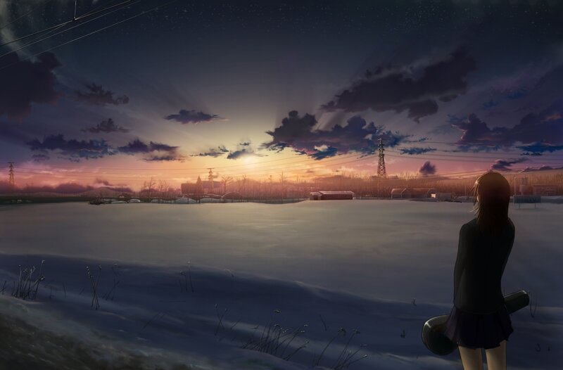 girl watching sunset in snowy field