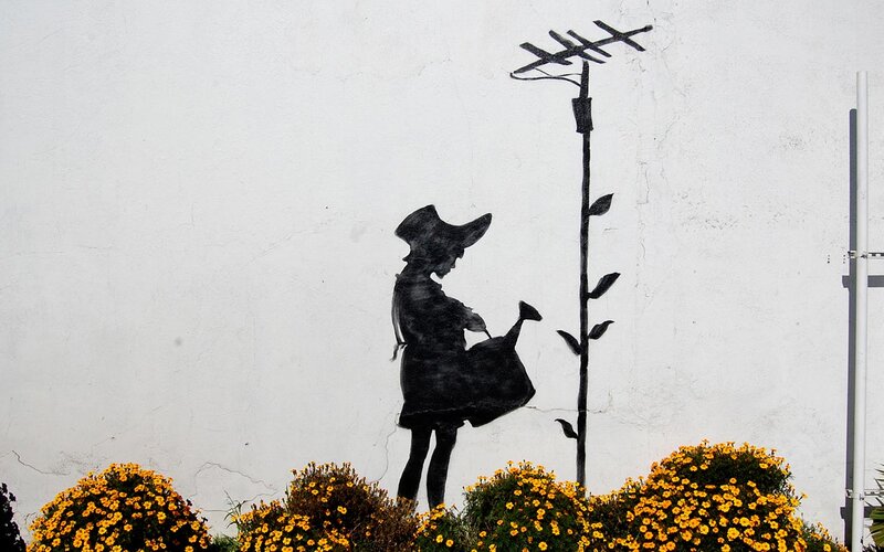 Girl watering plant mural