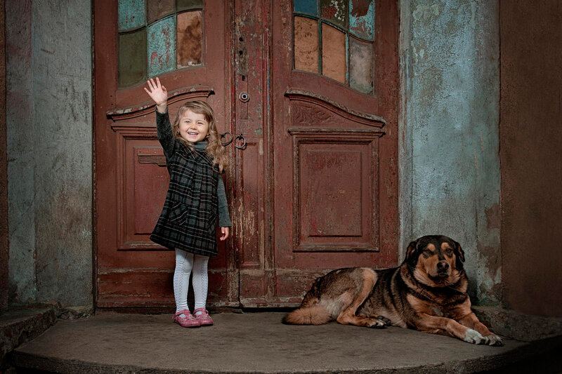 Girl Waving Beside Dog