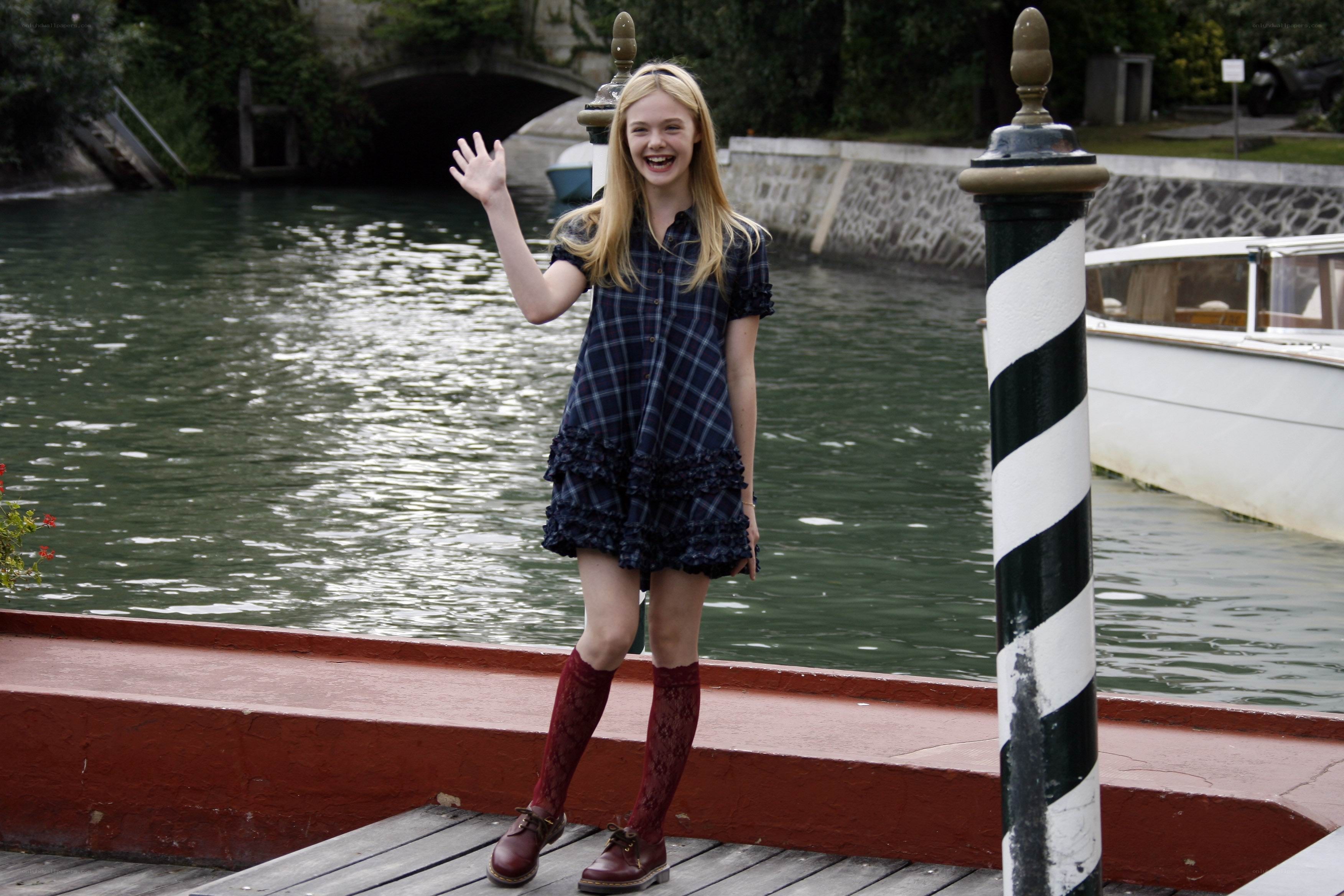 Girl waving by a canal
