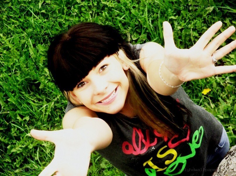 girl waving from grass