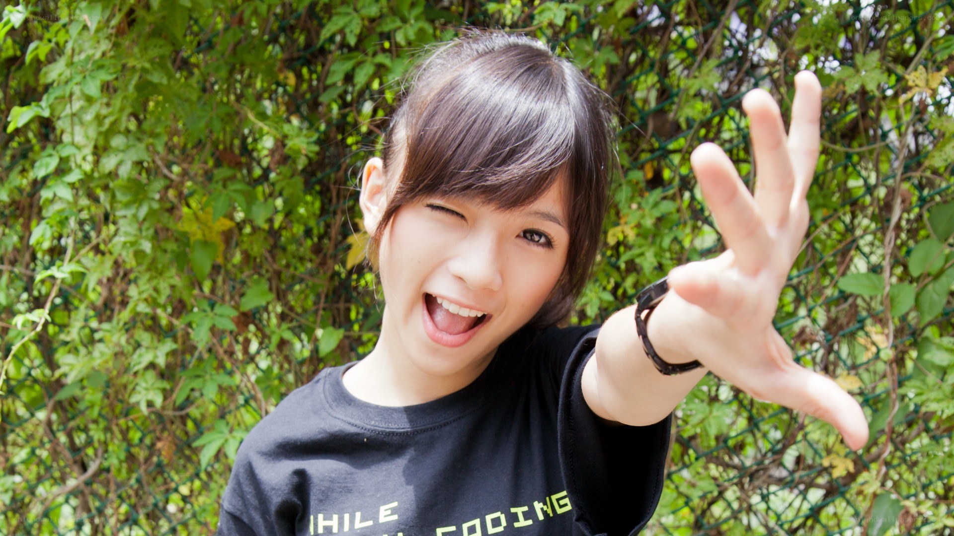 girl winking and waving