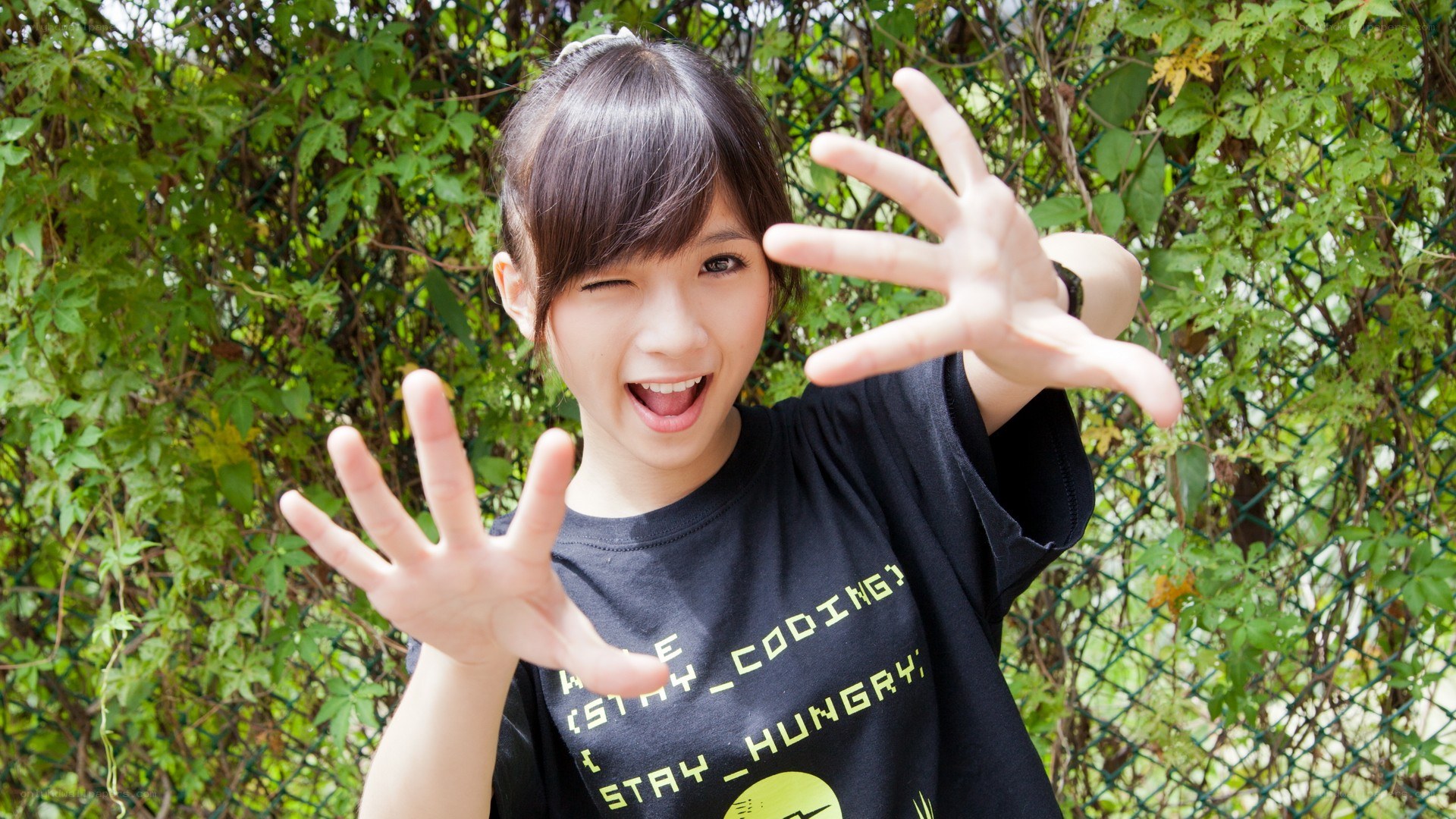 girl winking with hands out