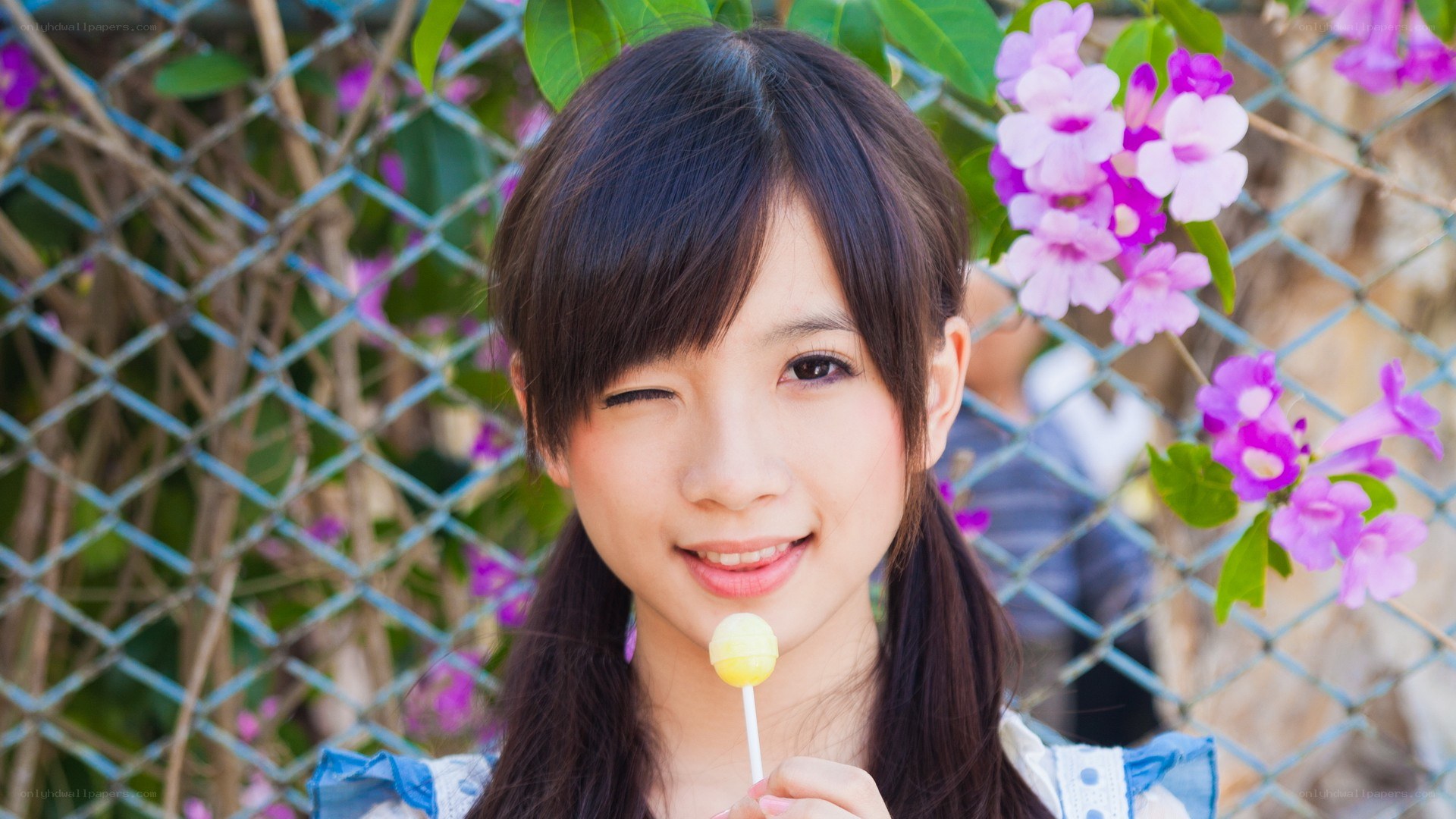 girl winking with lollipop