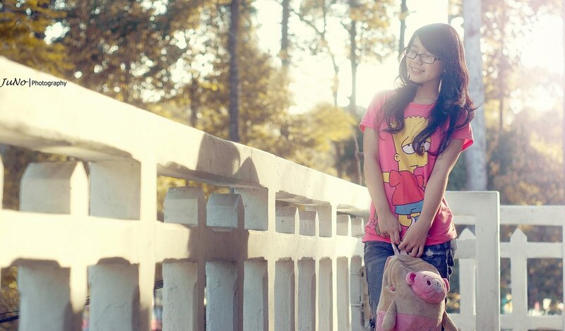 Girl with backpack on bridge