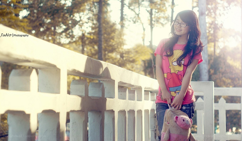 Girl with backpack on bridge