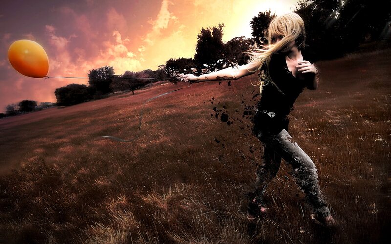 Girl with balloon in field