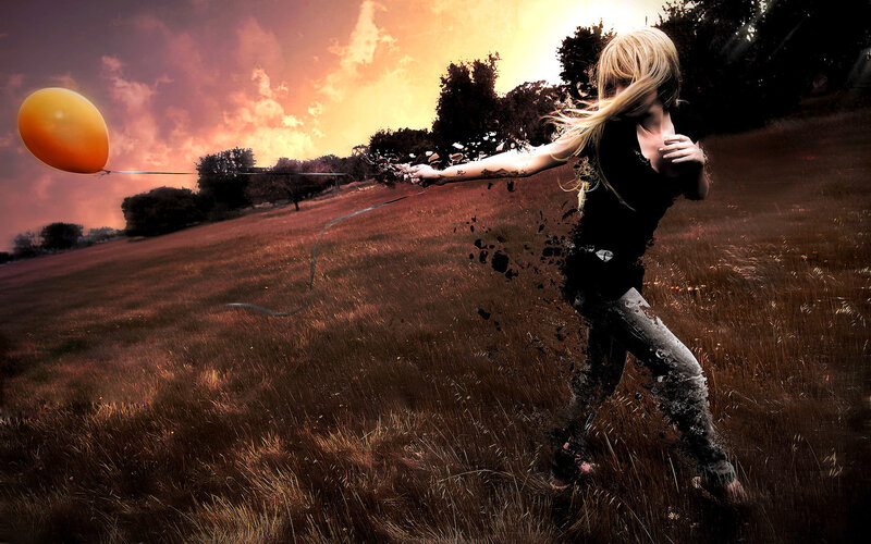 Girl with balloon in field