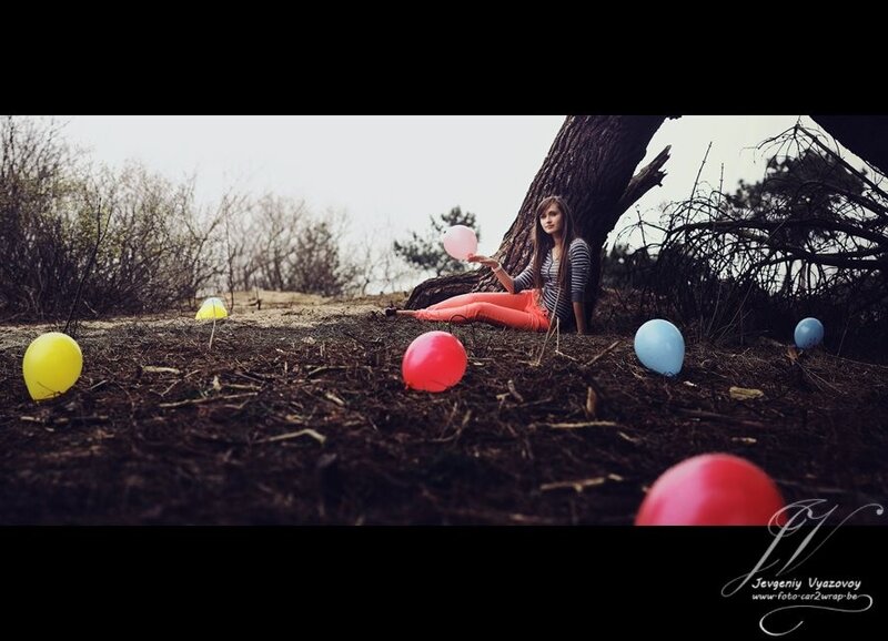 Girl with balloons in forest
