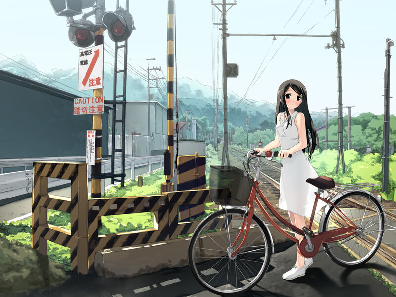 Girl with bicycle at train crossing