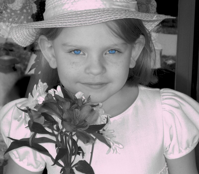 girl with blue eyes holding flowers