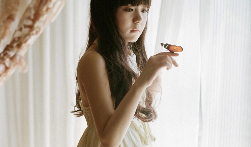 girl with butterfly on finger