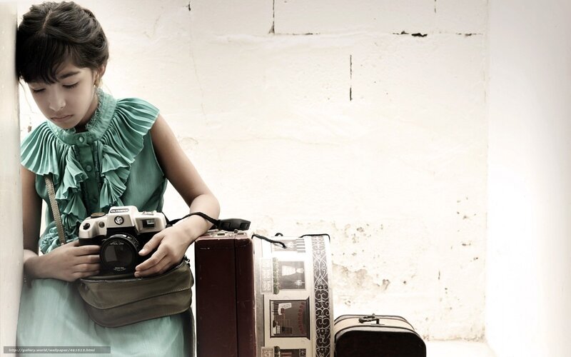 girl with camera and luggage