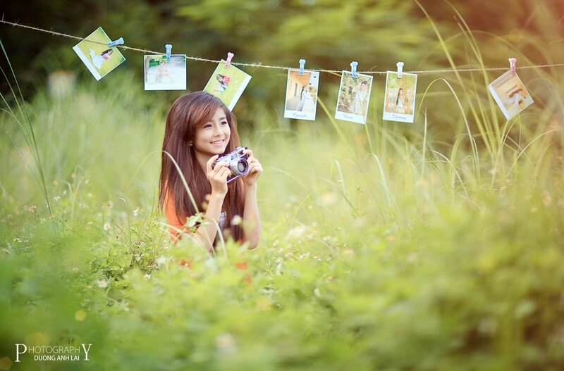 Girl with camera in field