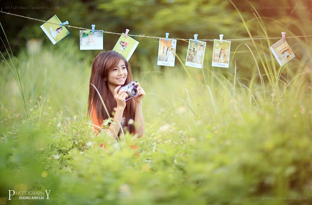 Girl with camera in field