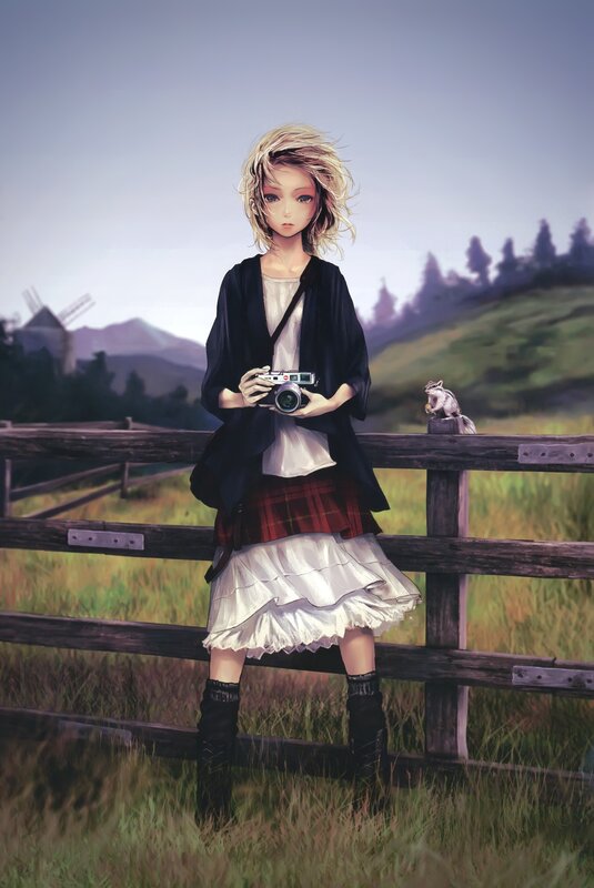 Girl with camera in field