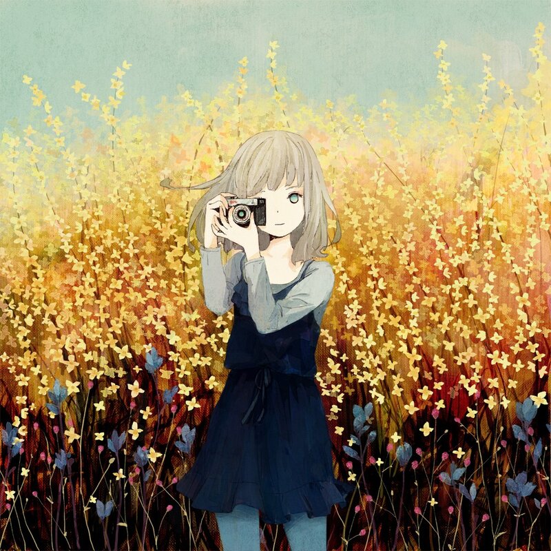 Girl with camera in flower field