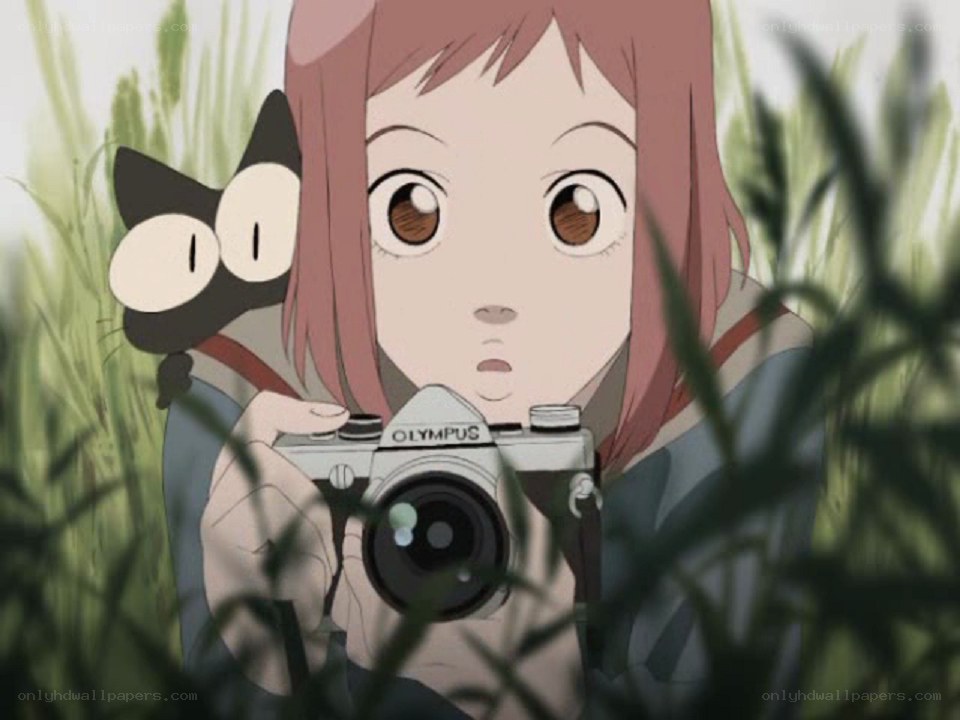 Girl with camera in grass