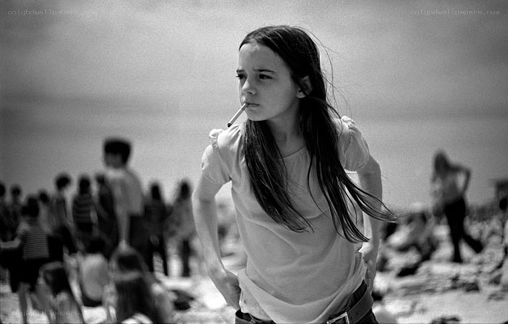 Girl with cigarette on beach