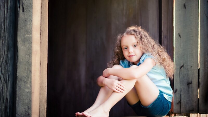 girl with curly hair sitting
