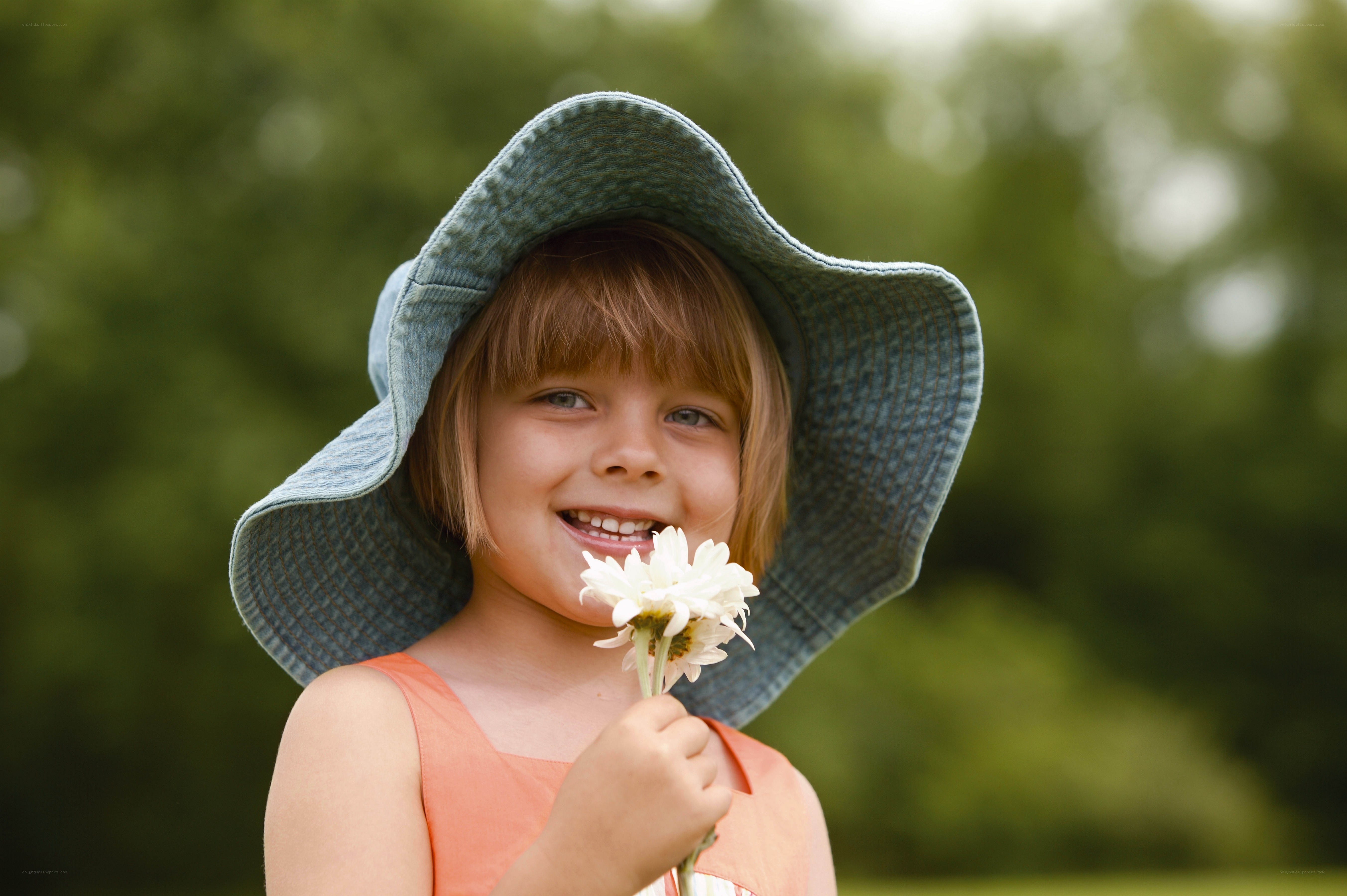 Girl with daisy in garden
