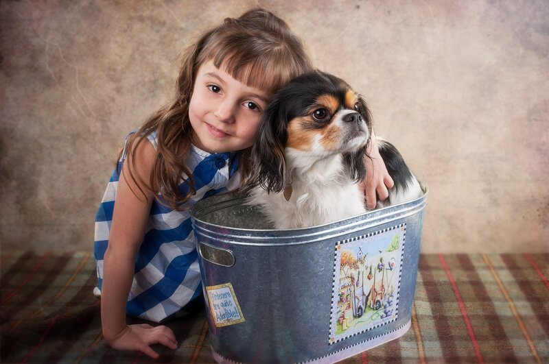 girl with dog in a tub