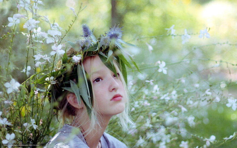 Girl with floral crown in garden