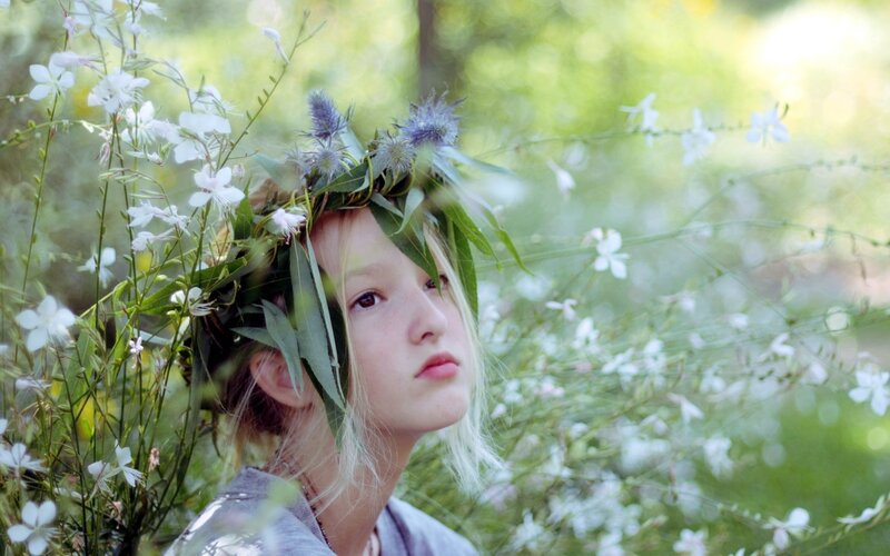 girl with flower crown in garden