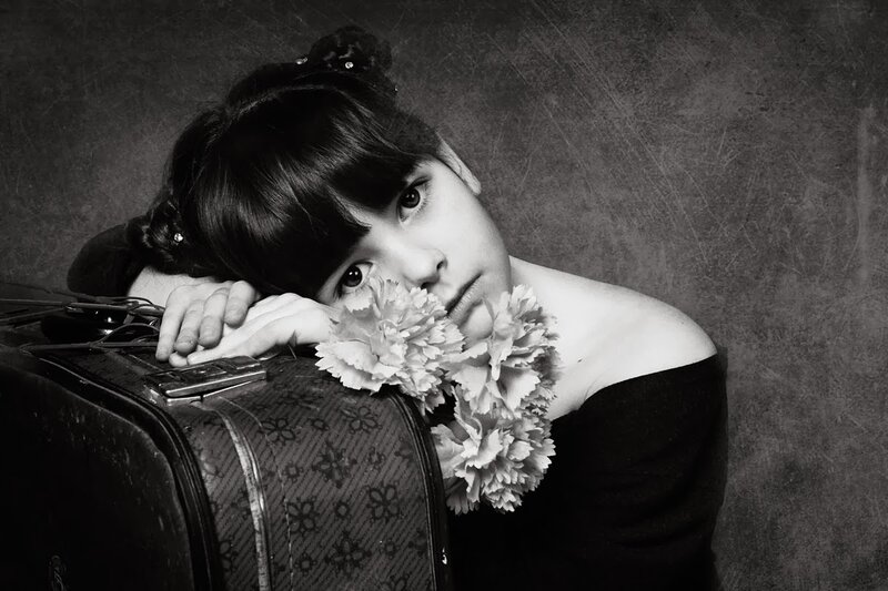 Girl with Flowers and Suitcase