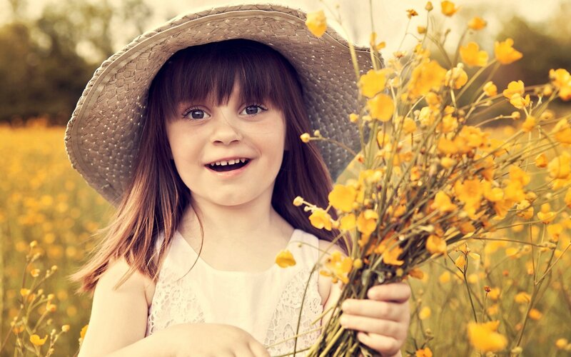 girl with flowers in field