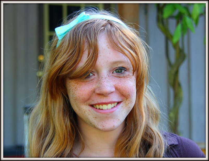 girl with freckles and bow