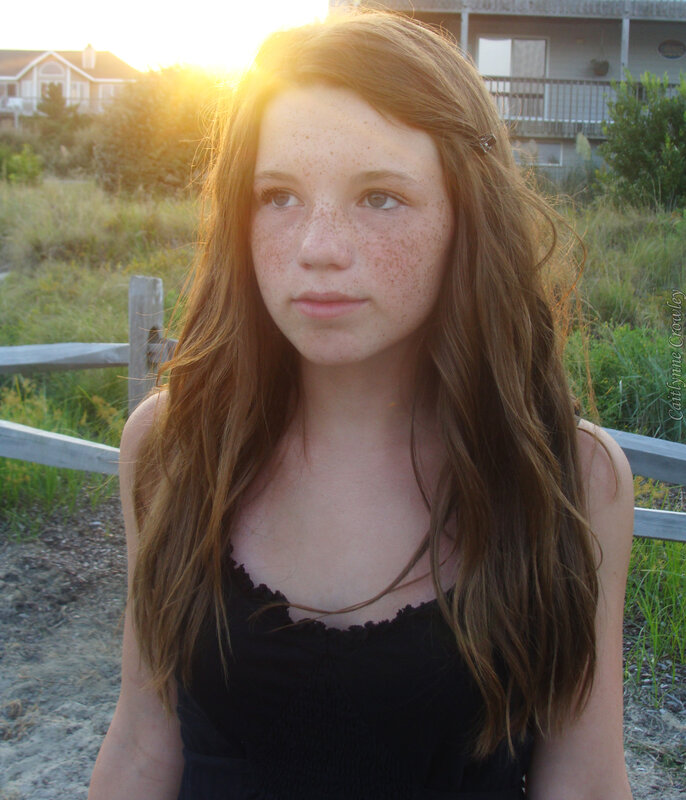 girl with freckles at sunset