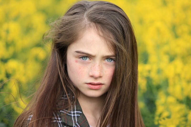 girl with freckles in a field